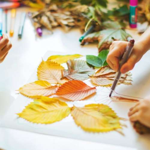 Children painting leaves.