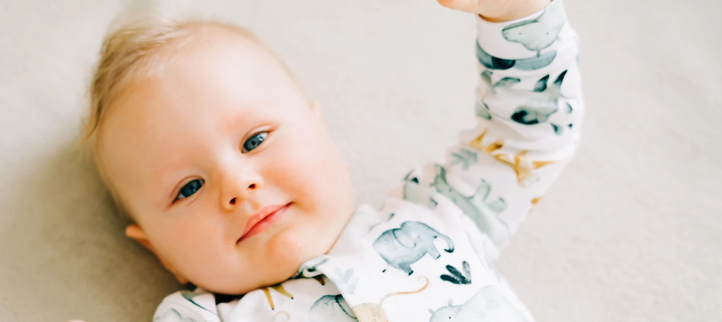 Baby in crib in a sleeper | Huckleberry