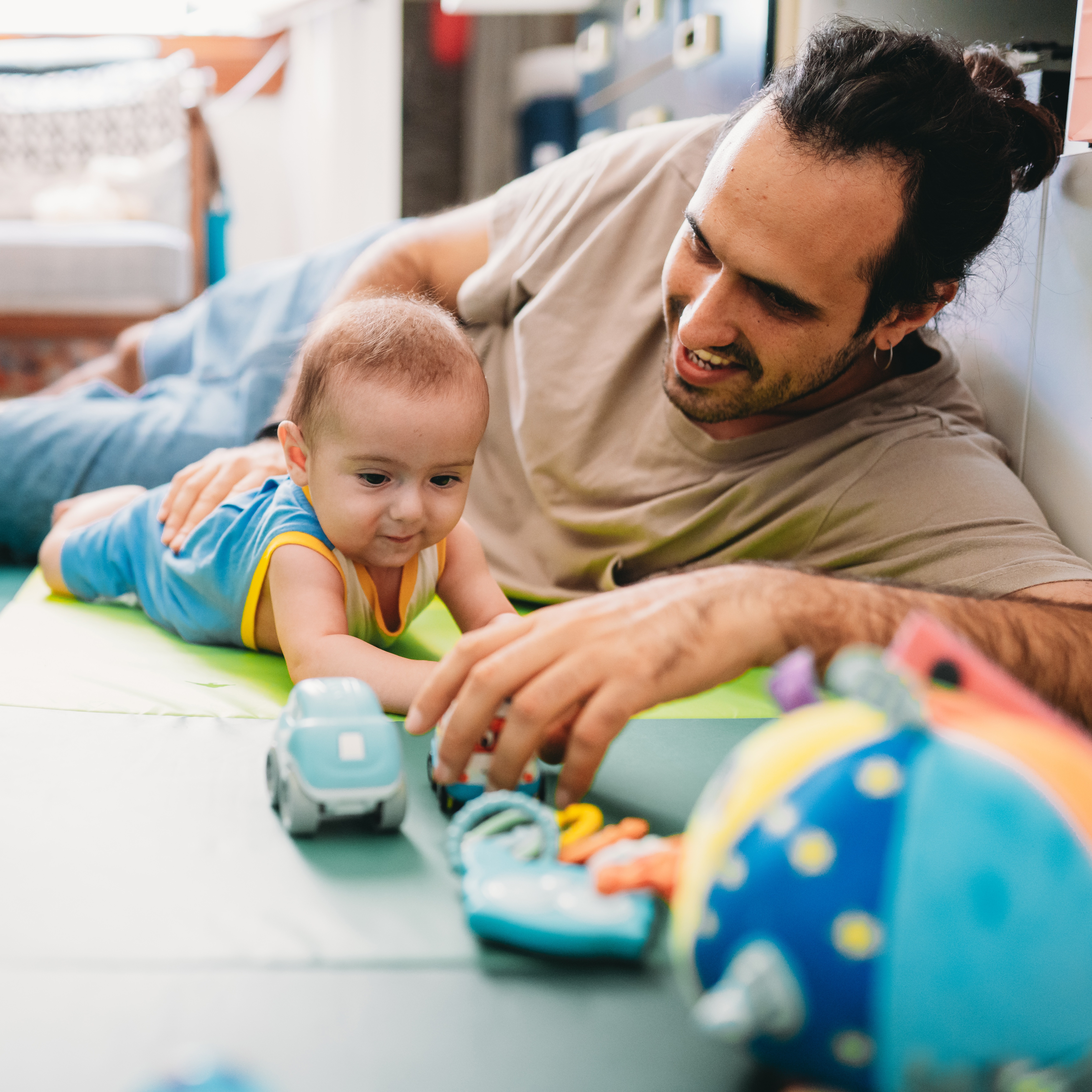 Baby doing tummy time with dad