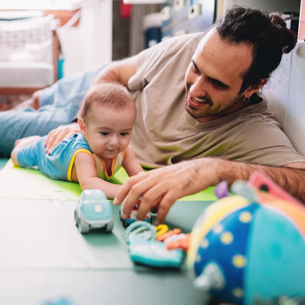 Baby doing tummy time with dad