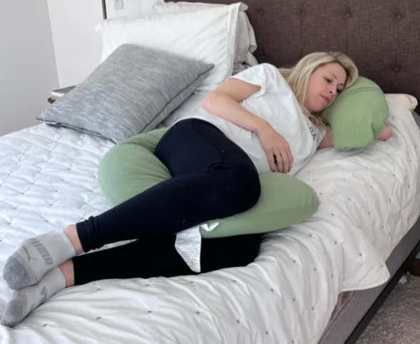 By placing the C-shaped pregnancy pillow behind your back, laying your head on the part that reaches around, and placing the end between your knees, it will give optimal back support.