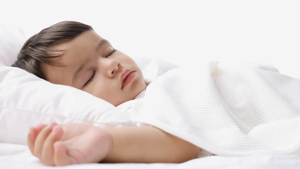 Toddler sleeping with blanket on