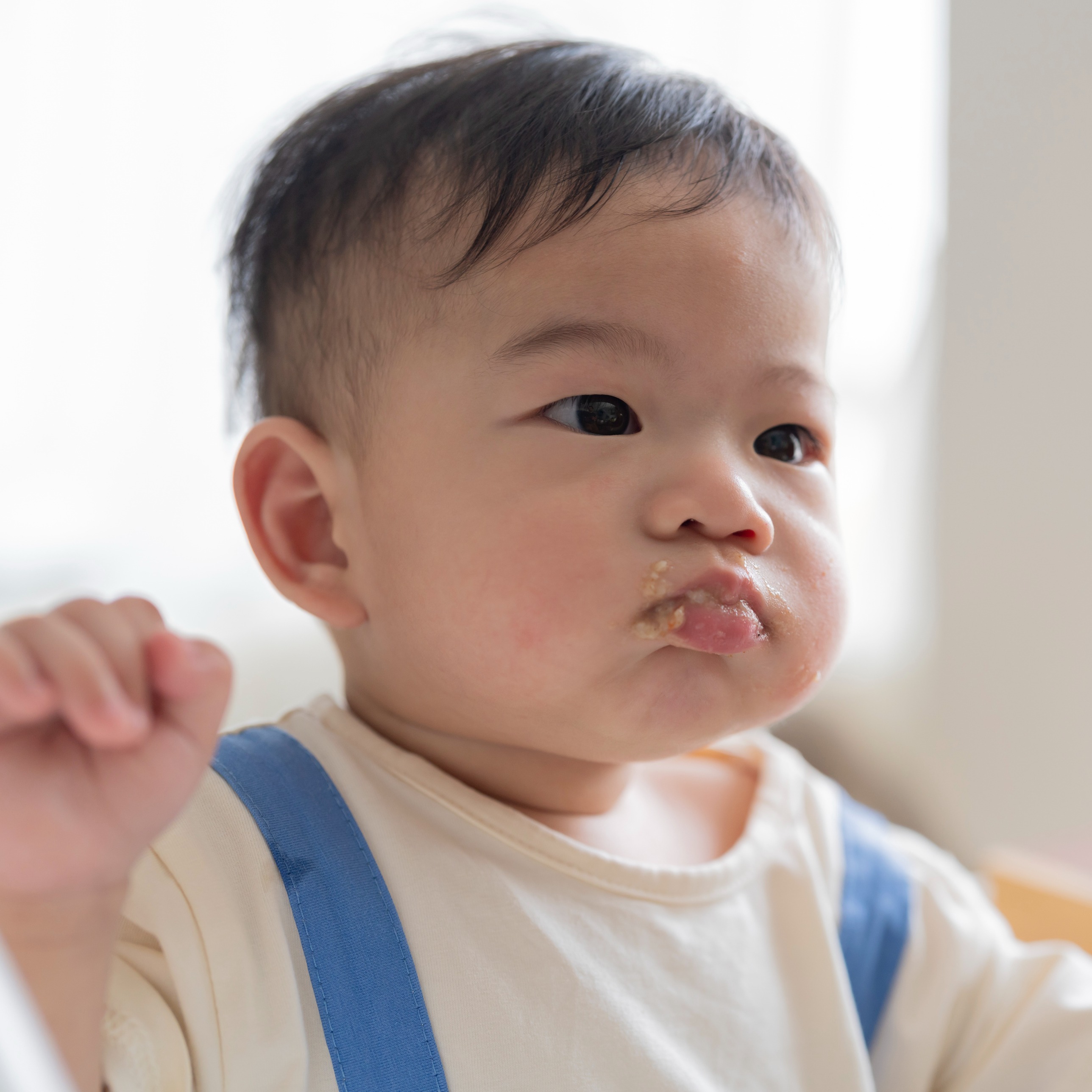 Baby eating applesauce with cinnamon