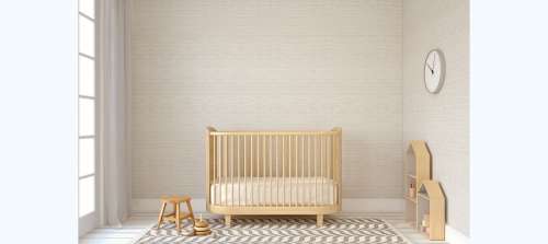 Wooden crib in neutral nursery room