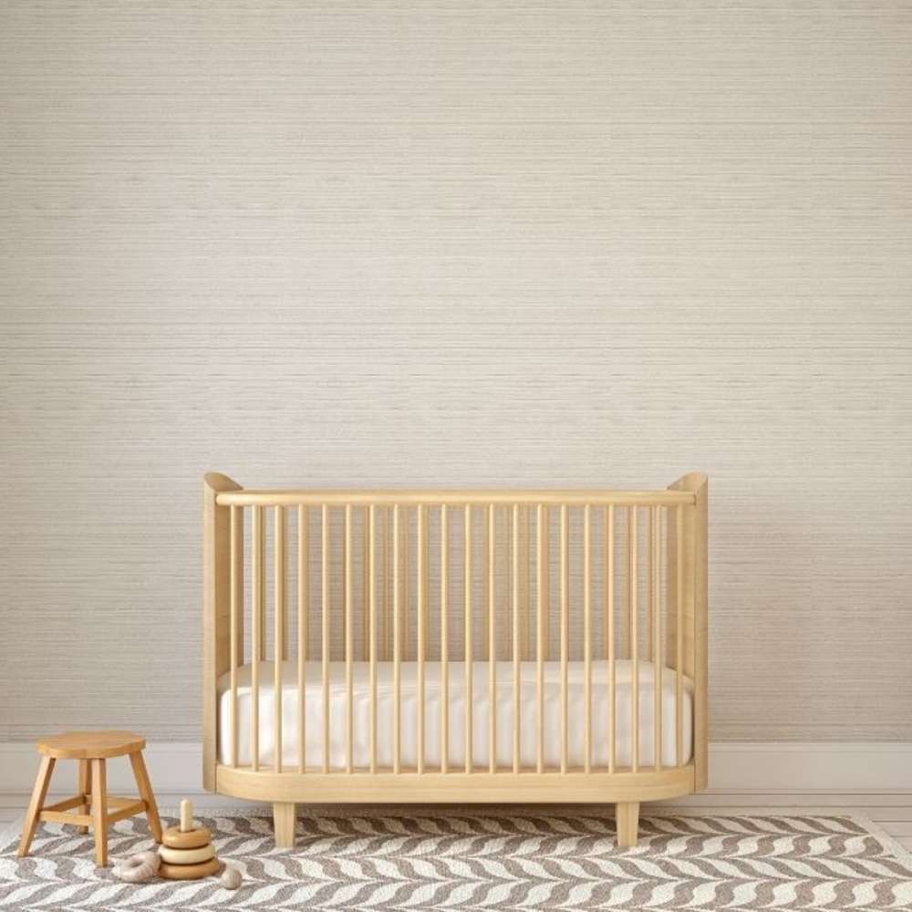 Wooden crib in neutral nursery room