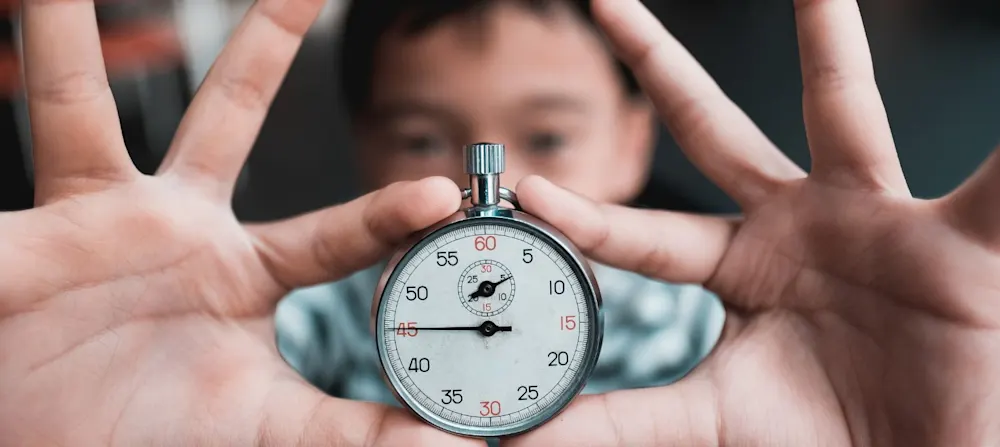 A child holding a timer.