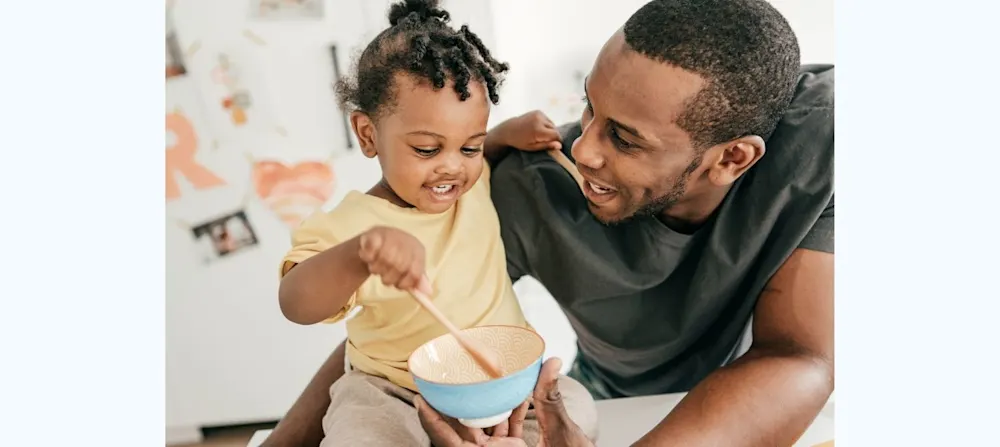 Toddler girl with dad, both smiling