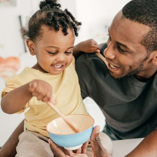 Toddler girl with dad, both smiling