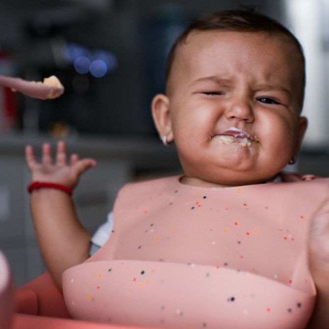 Baby eating solids and protesting