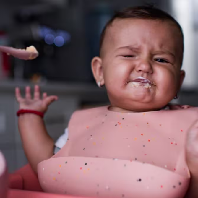 Baby eating solids and protesting