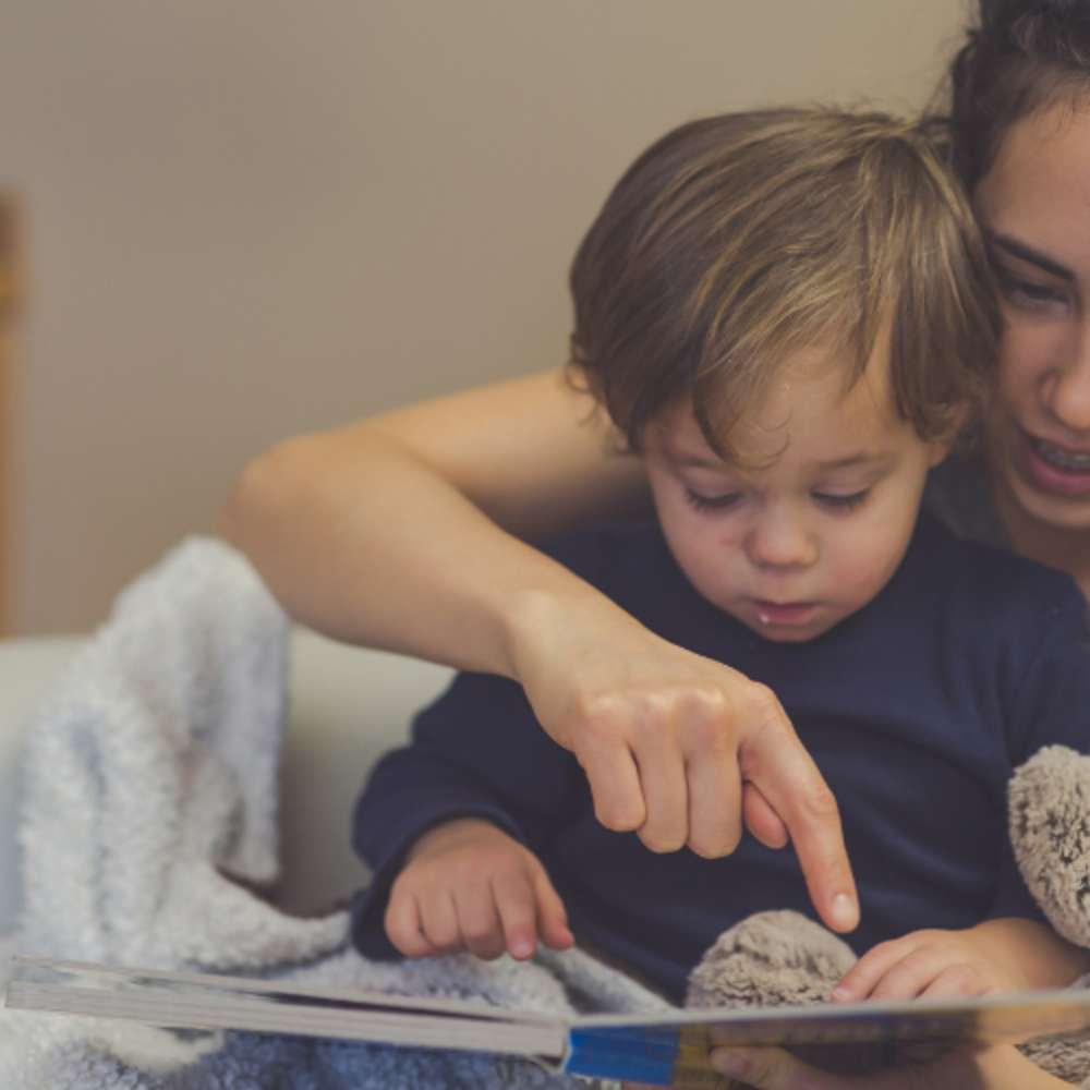 Mom reading to baby before bed time