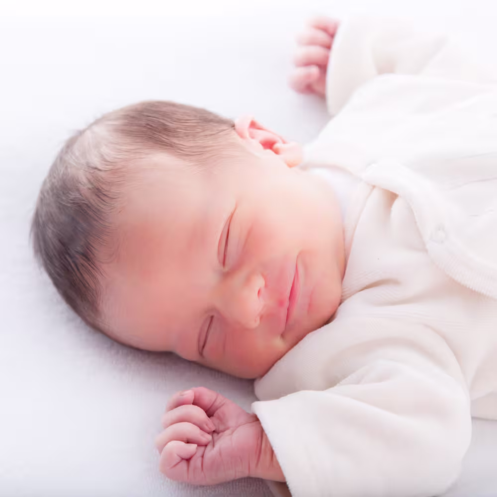 Baby smiling in sleep.