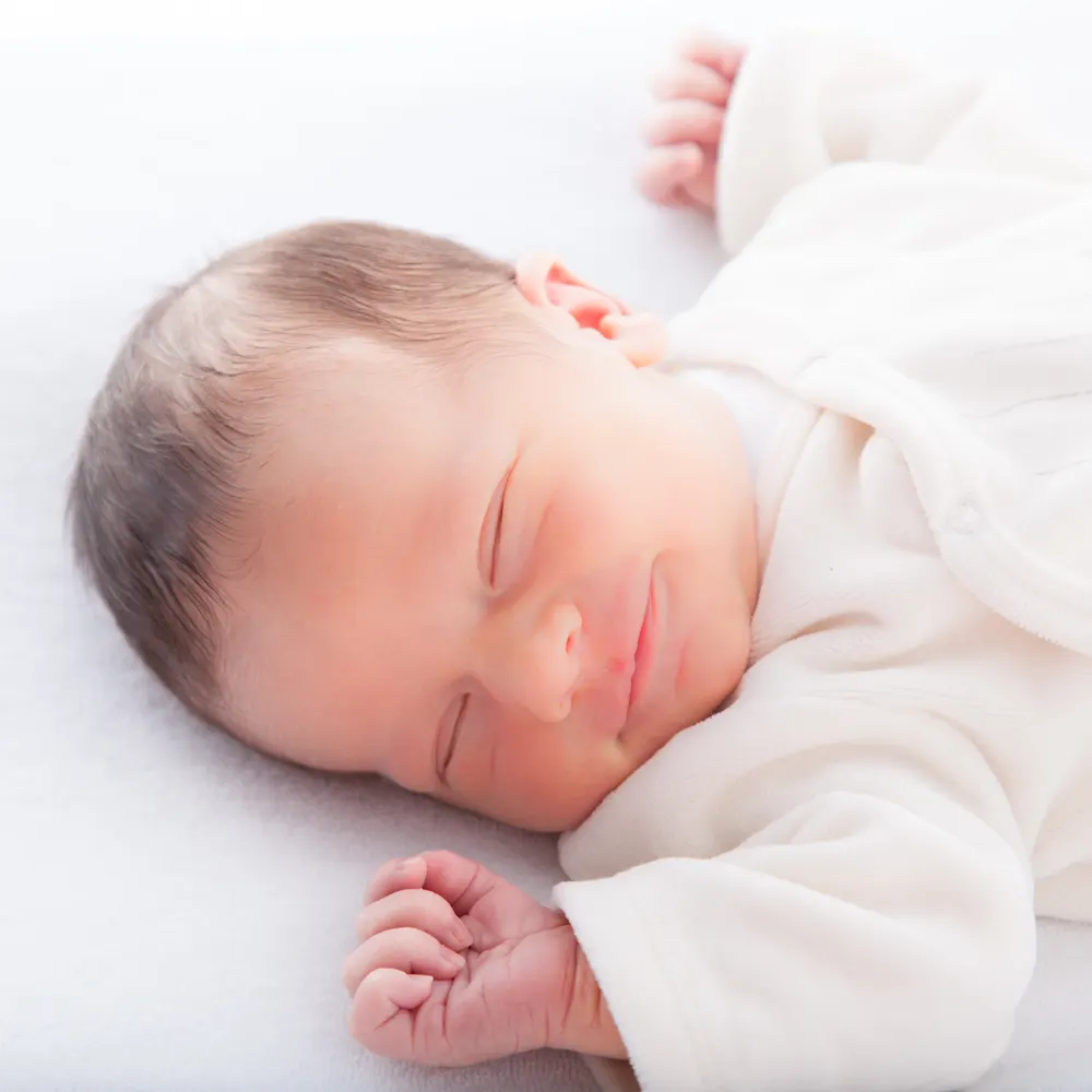 Baby smiling in sleep.