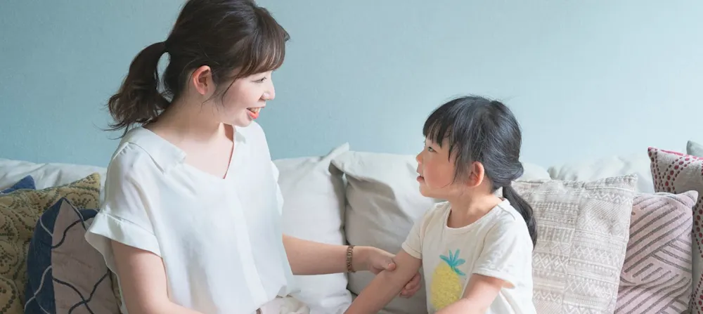 A mother talking to her younger child.