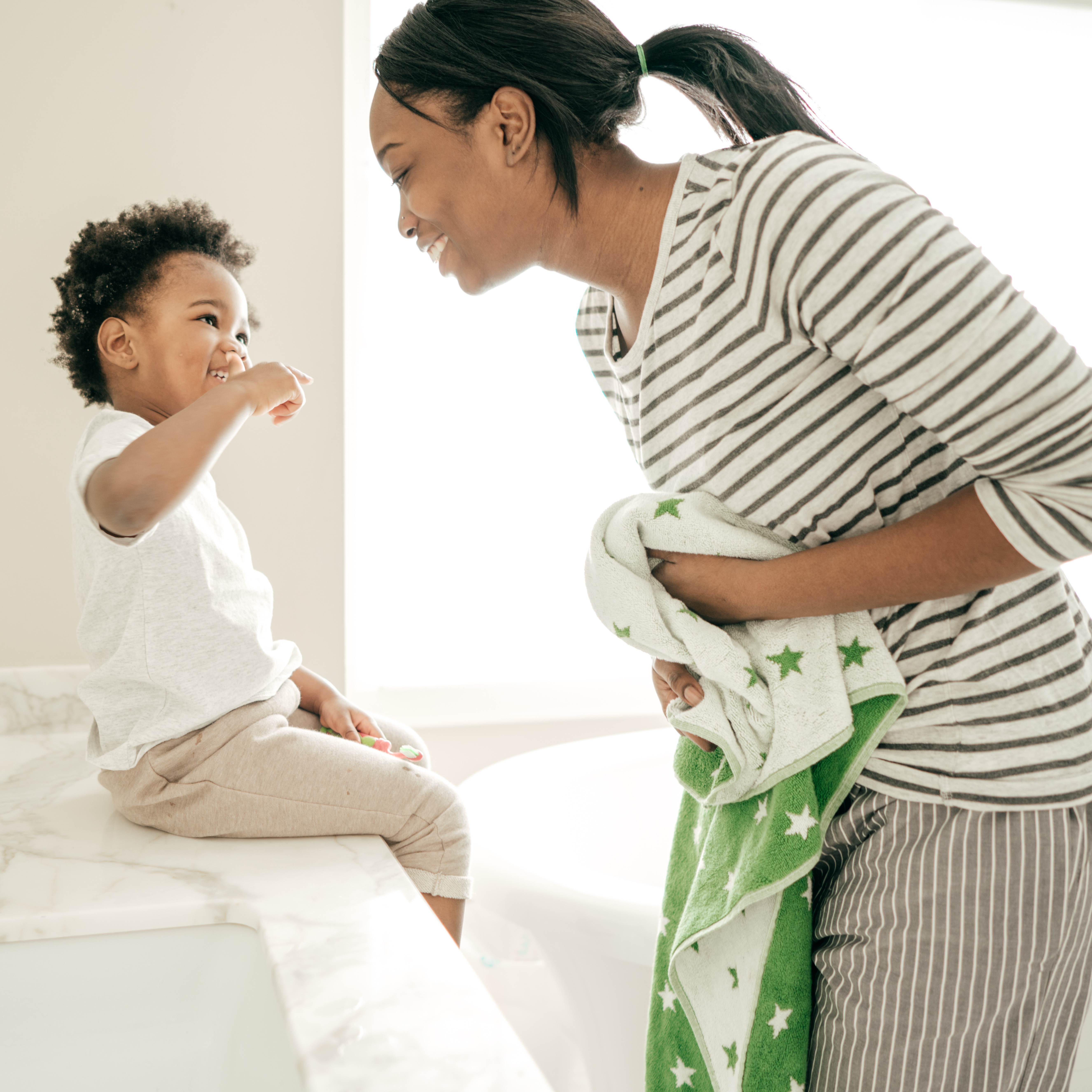 Toddler and parent brushing teeth as part of the bedtime routine