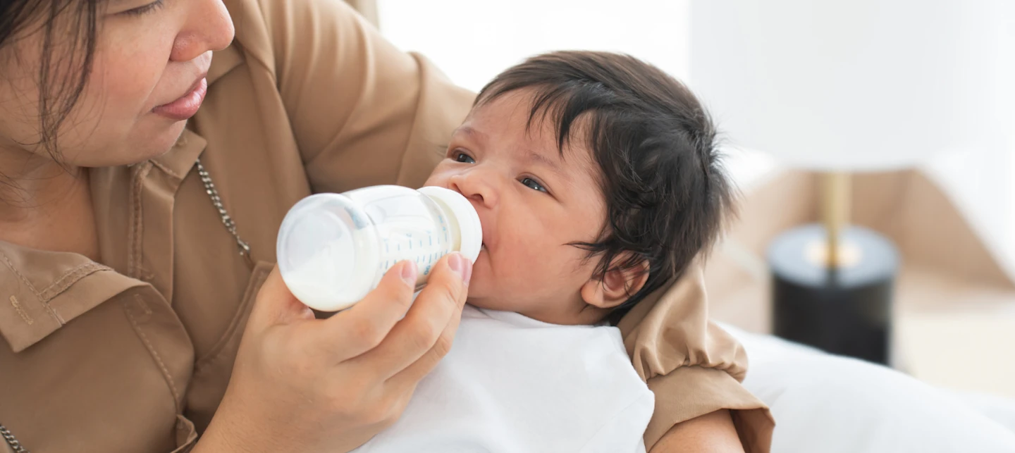 Mother using paced feeding while giving a bottle to baby | Huckleberry