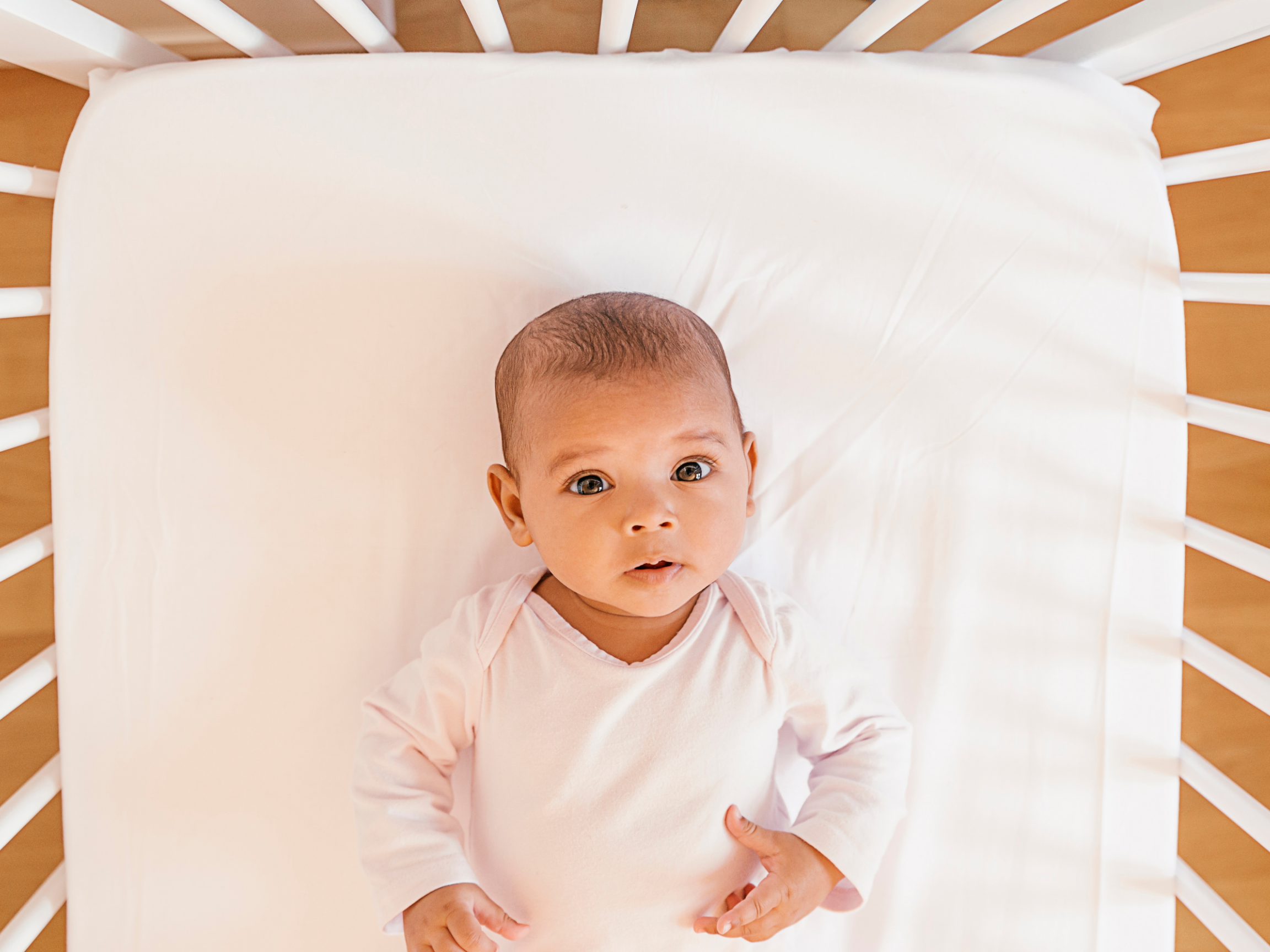 baby laying down awake in crib