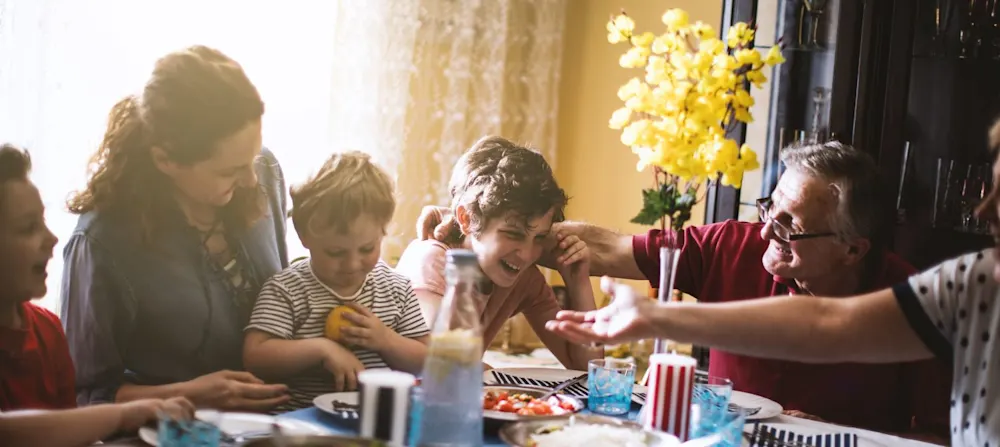 A family sitting at the dinner table.
