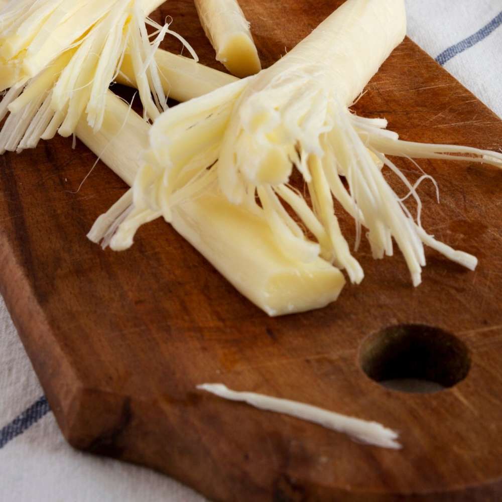 String cheese on cutting board closeup