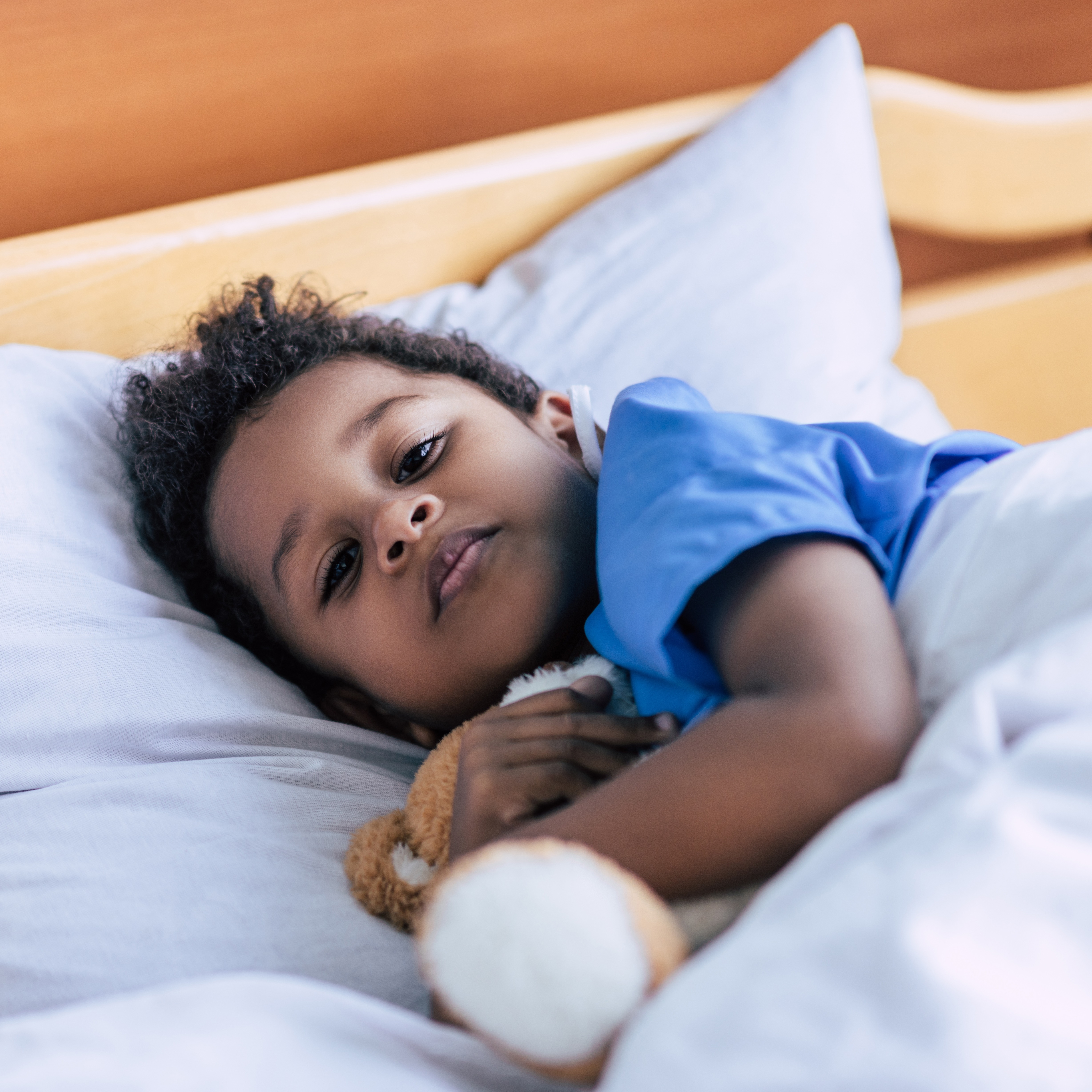 Child in bed listening to audiobook