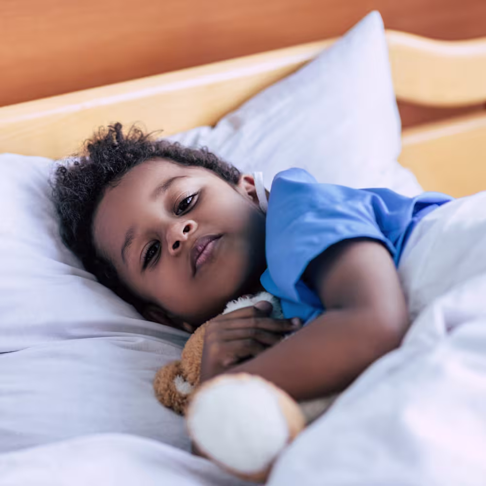 Child in bed listening to audiobook