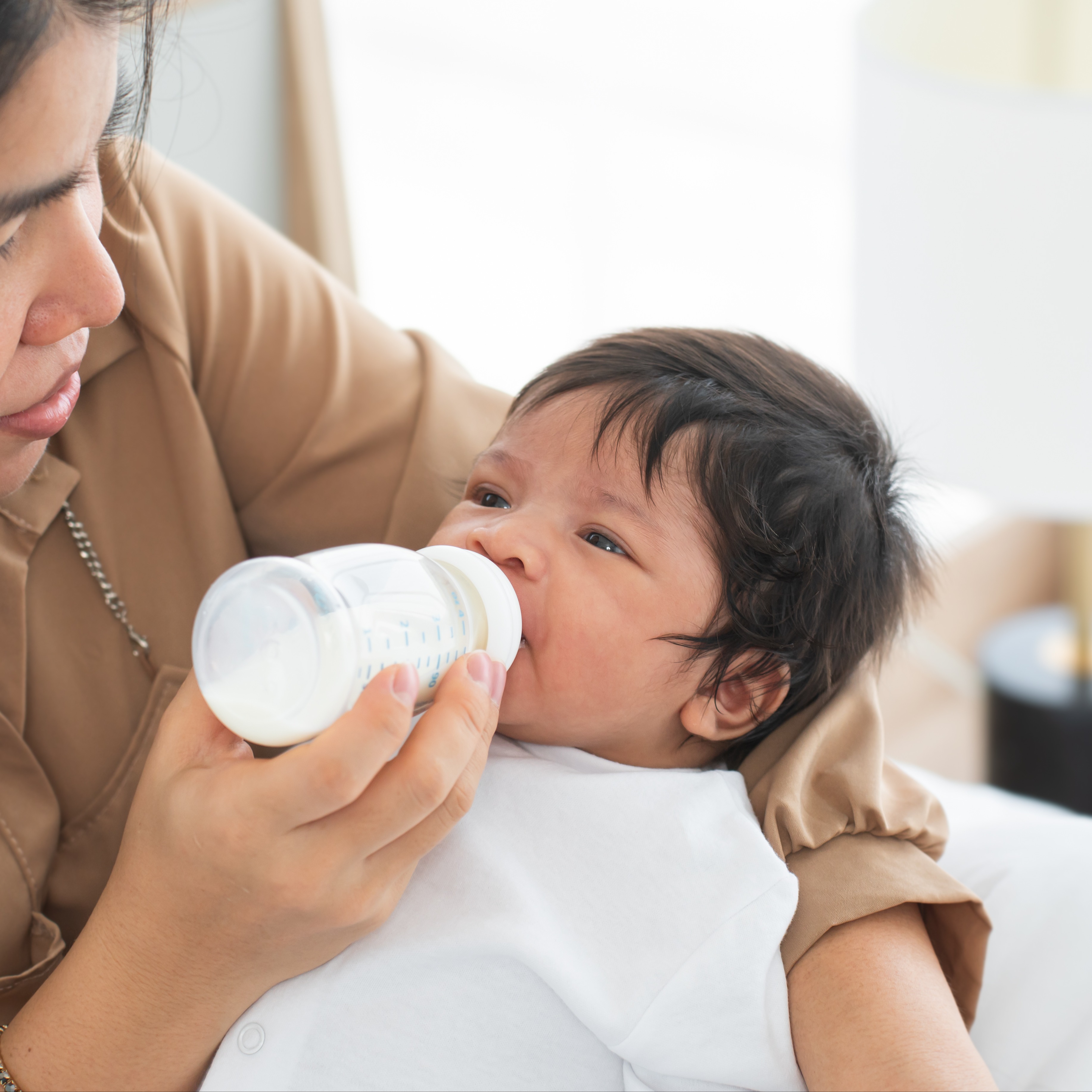 Baby getting a bottle using paced feeding