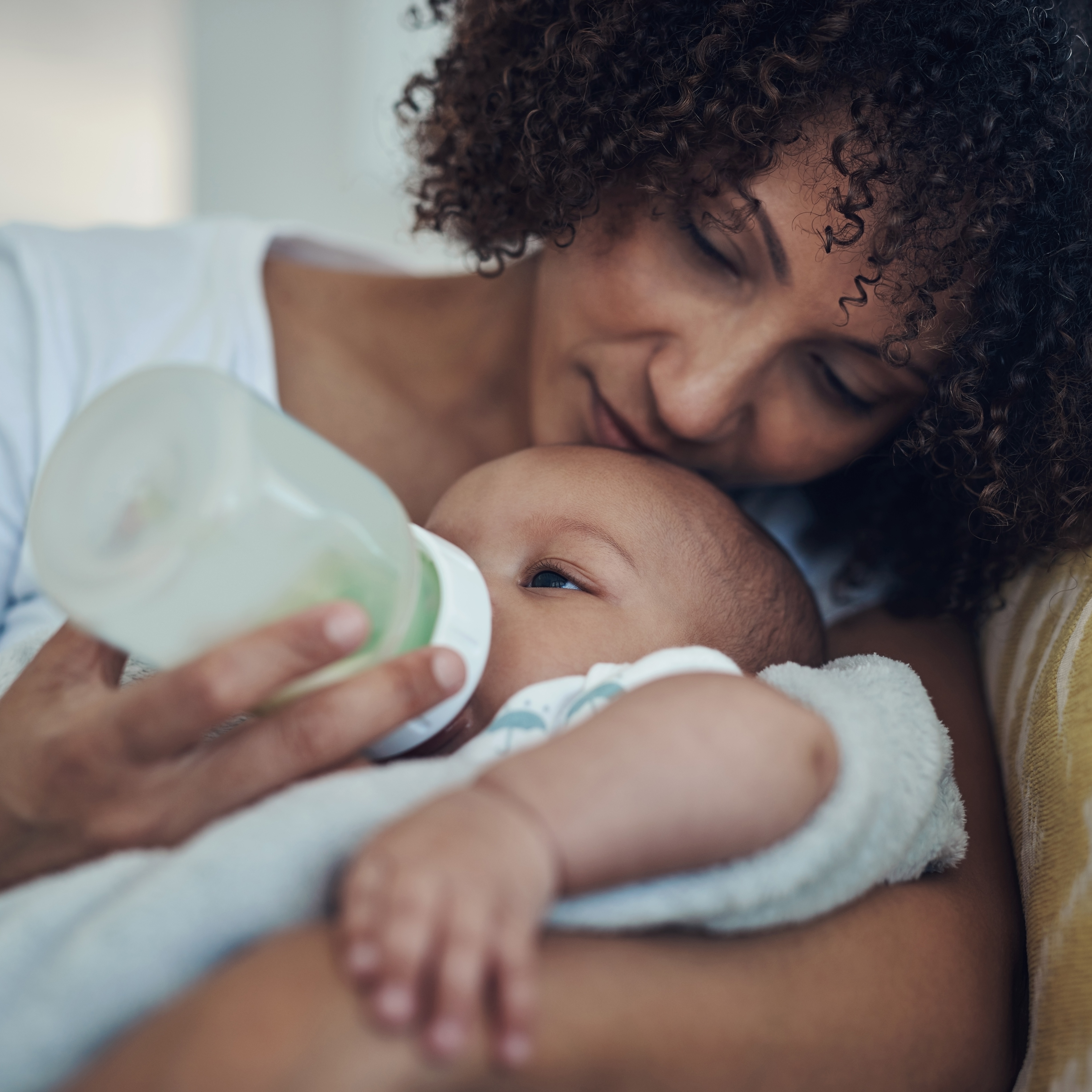 Mother giving her baby a bottle.