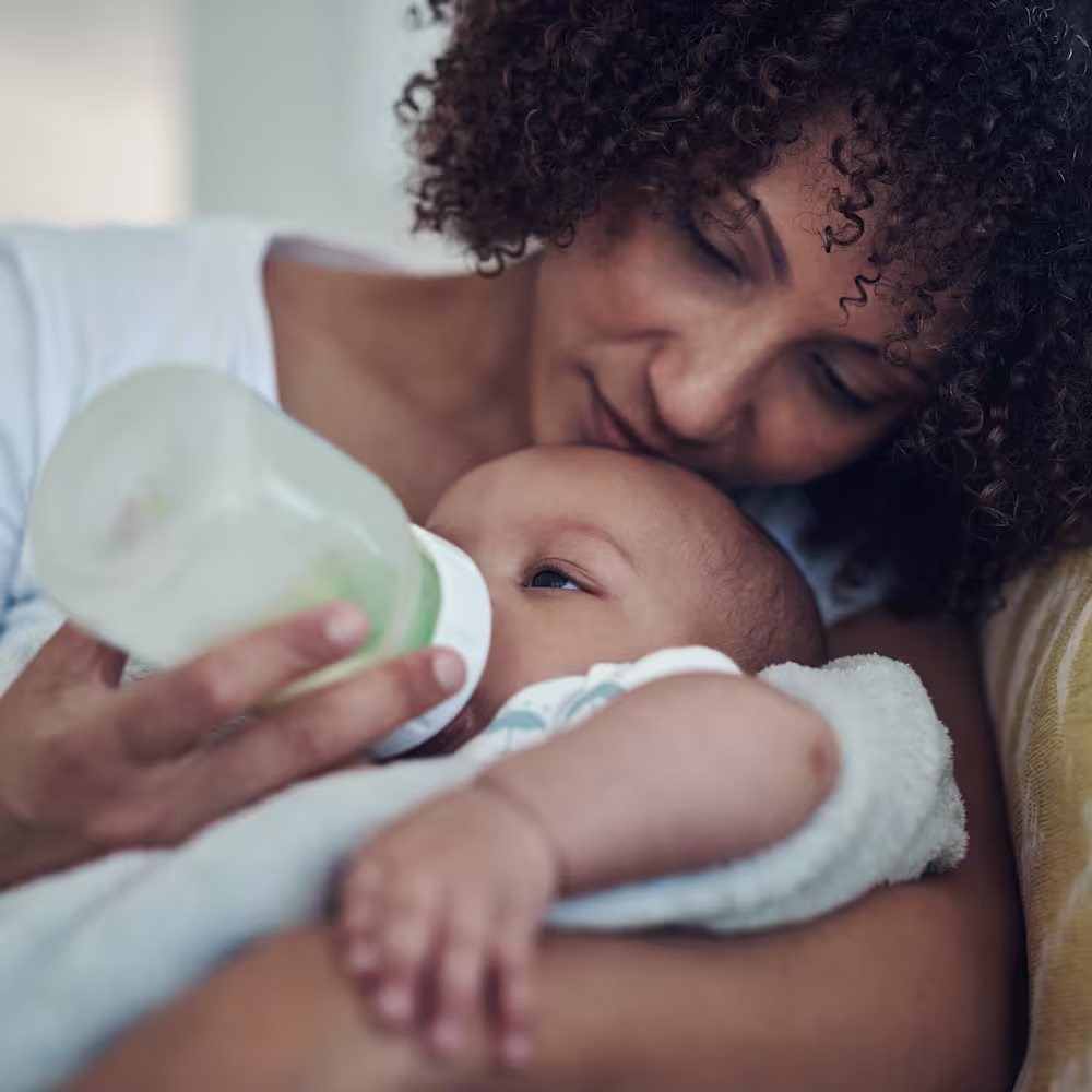 Mother giving her baby a bottle.