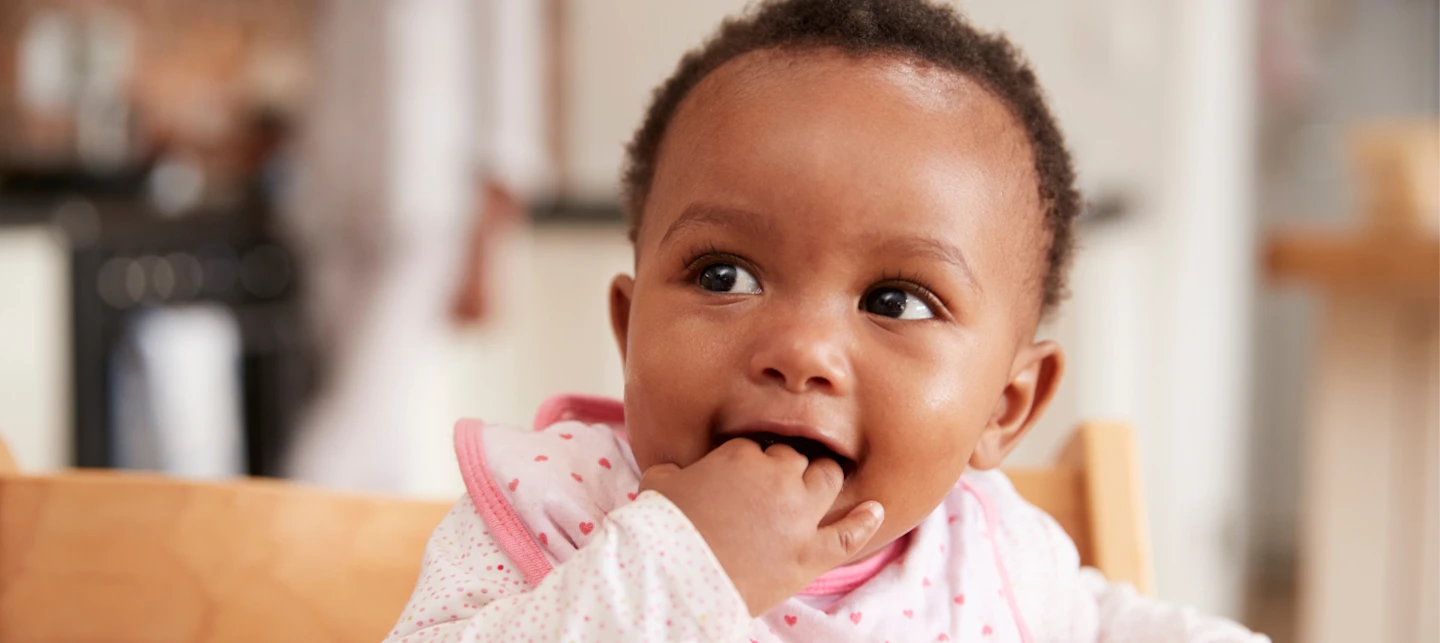 Baby feeding schedule by age - baby in high chair ready to eat | Huckleberry