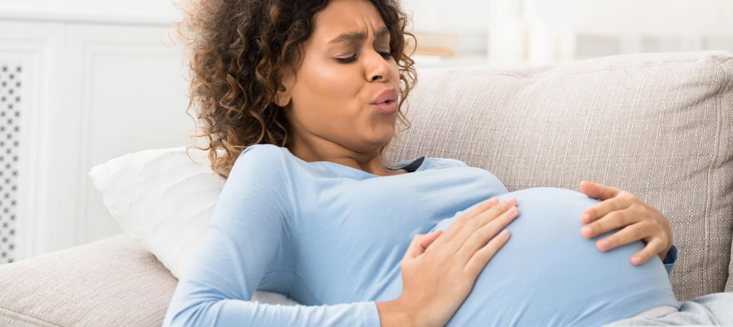Woman having contractions while pregnant | Huckleberry