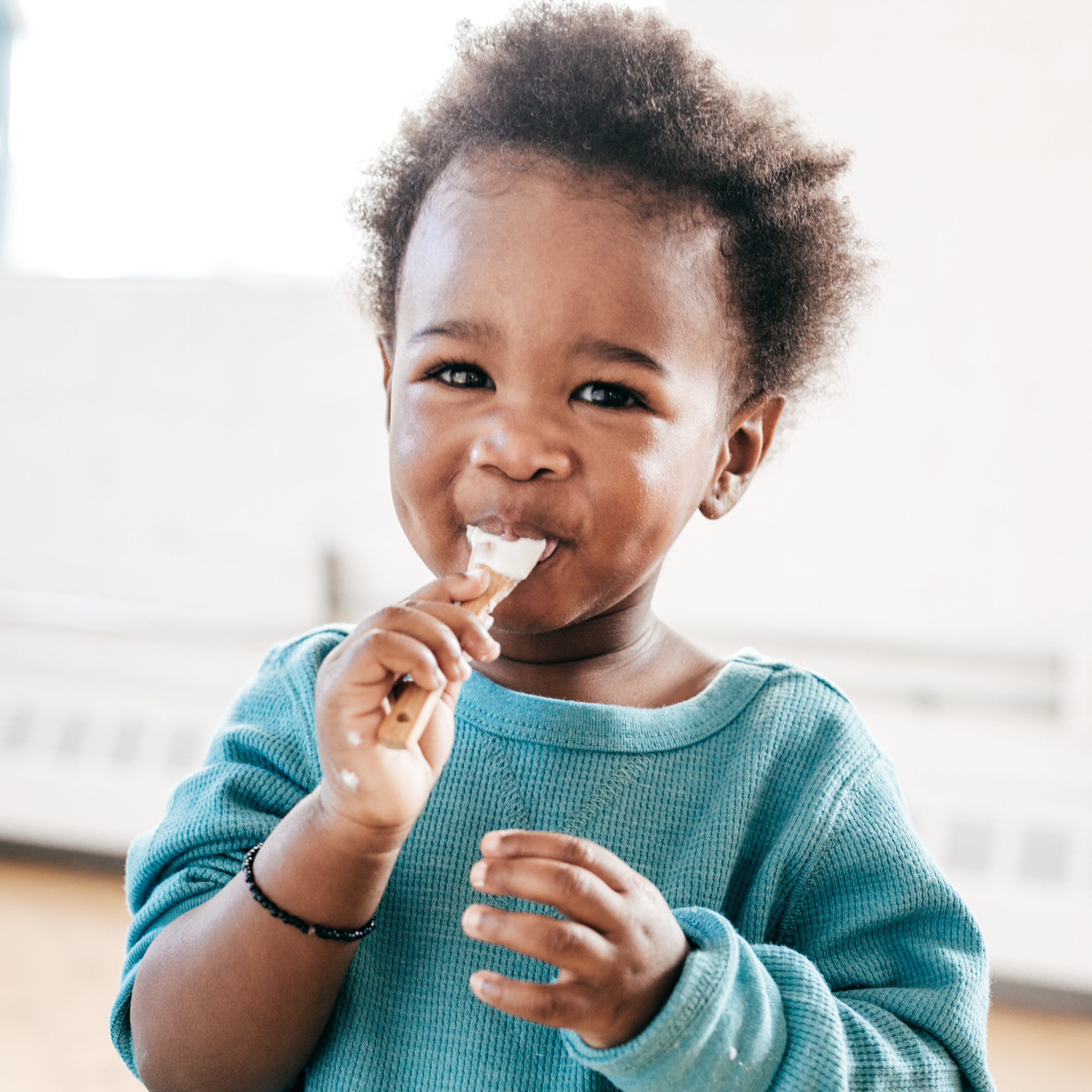 Toddler eating yogurt