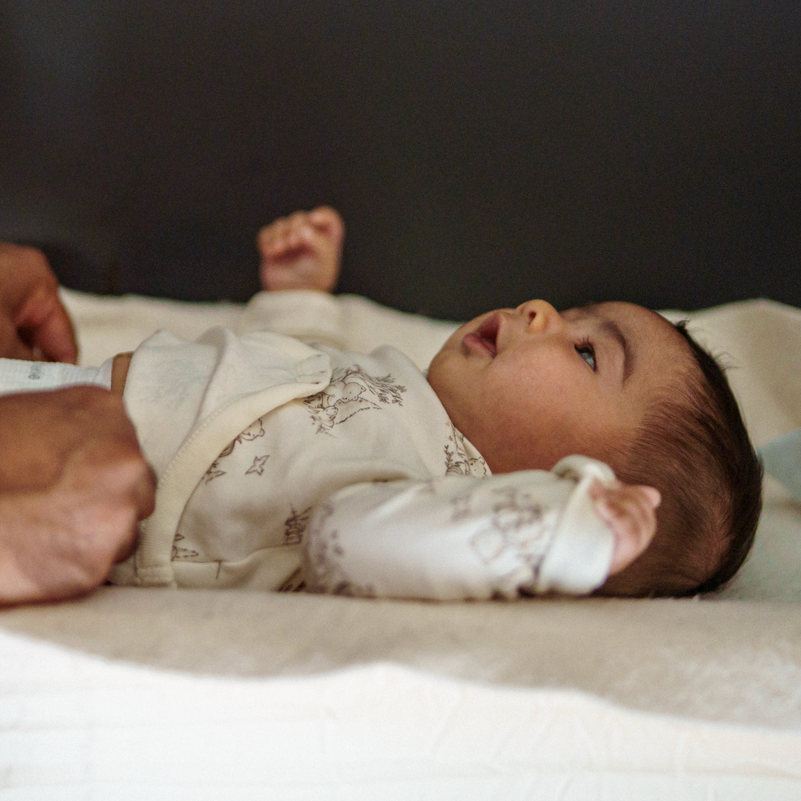 Father changing newborn baby on his night shift