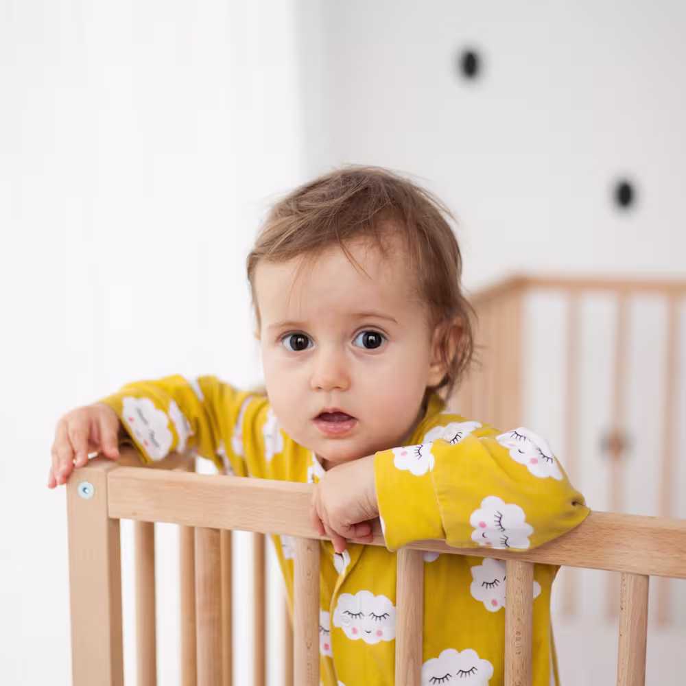 Toddler looking out from crib.