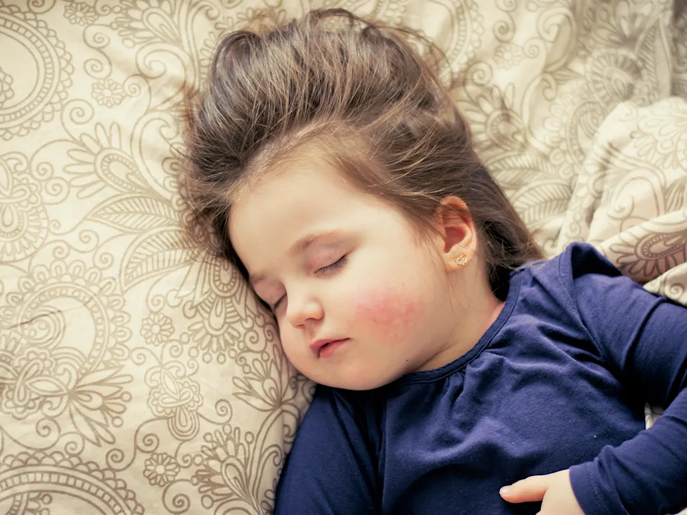 Toddler girl sleeping in her bed
