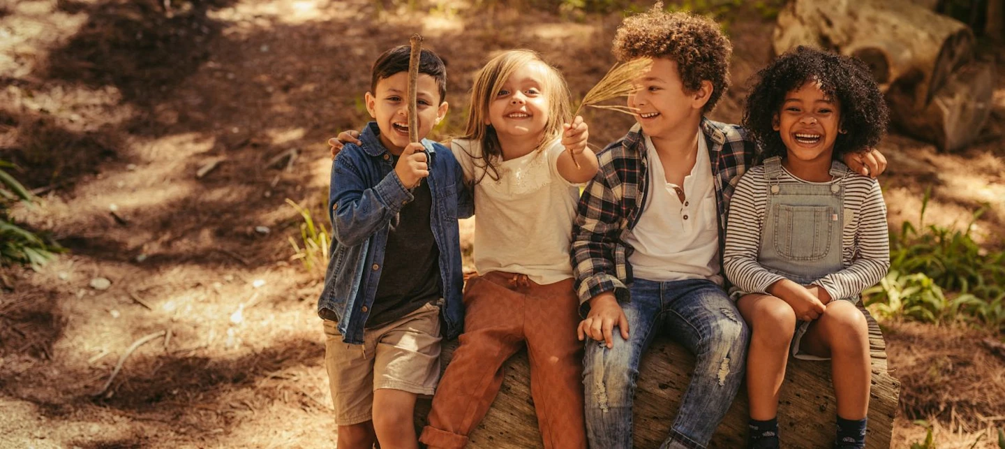 A group of four children playing outside. | Huckleberry