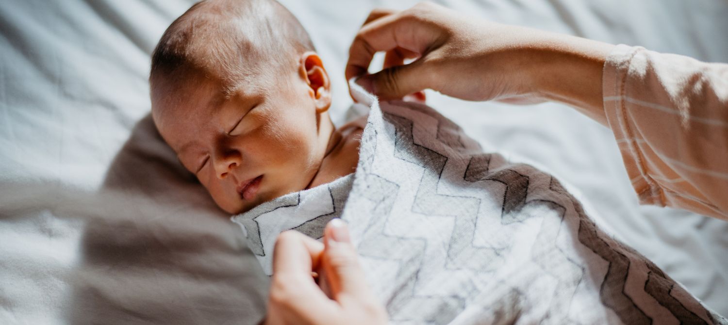 Swaddle newborn at store night