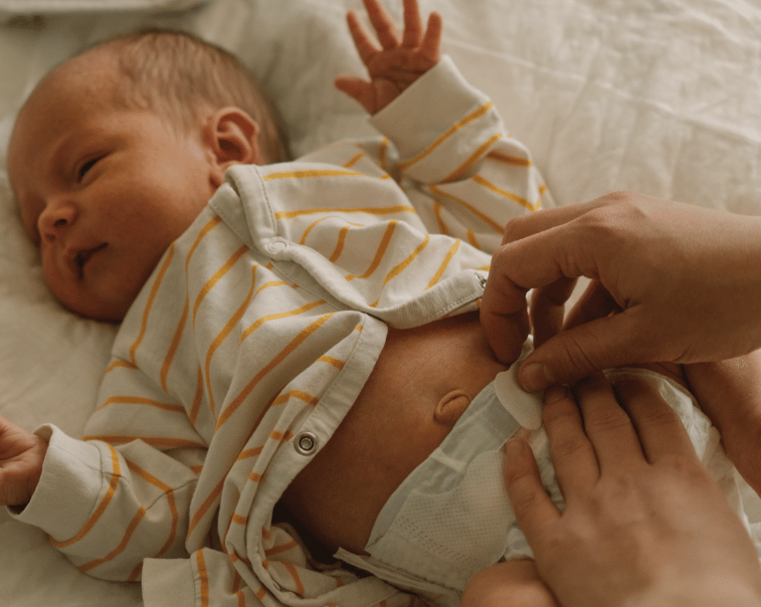 Baby getting diaper changed for first poops