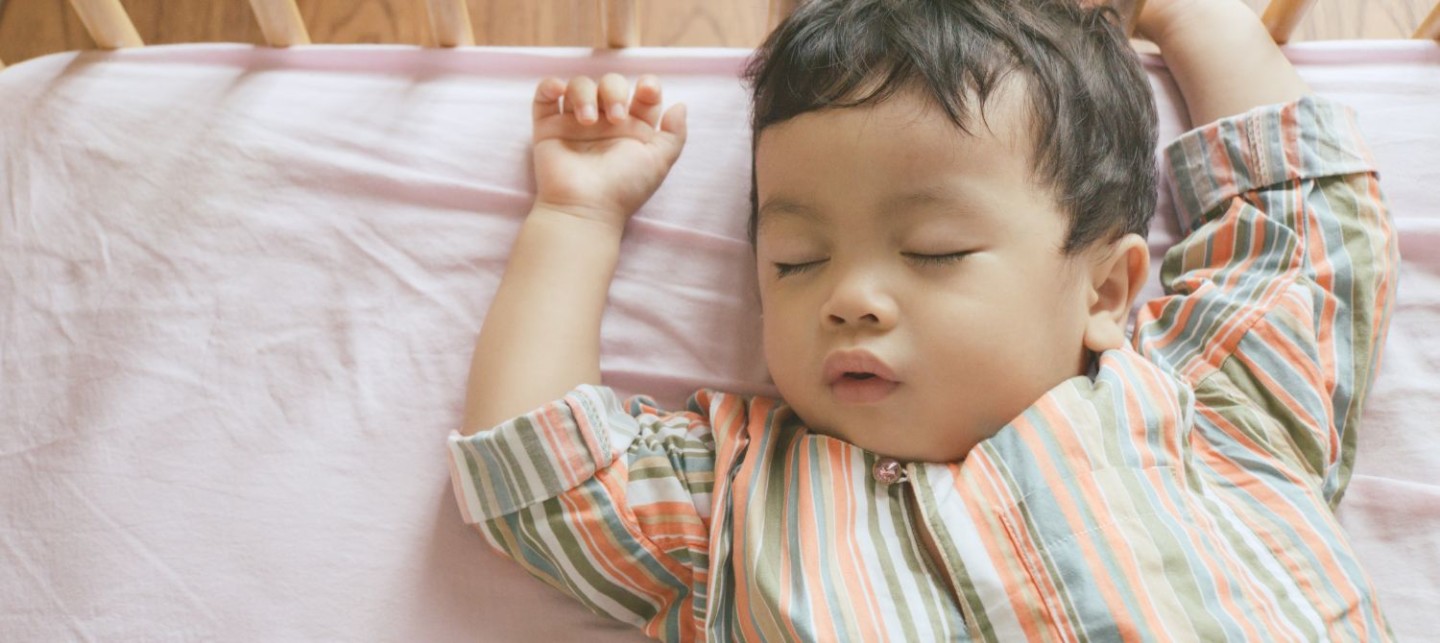 A baby sleeping in a crib.