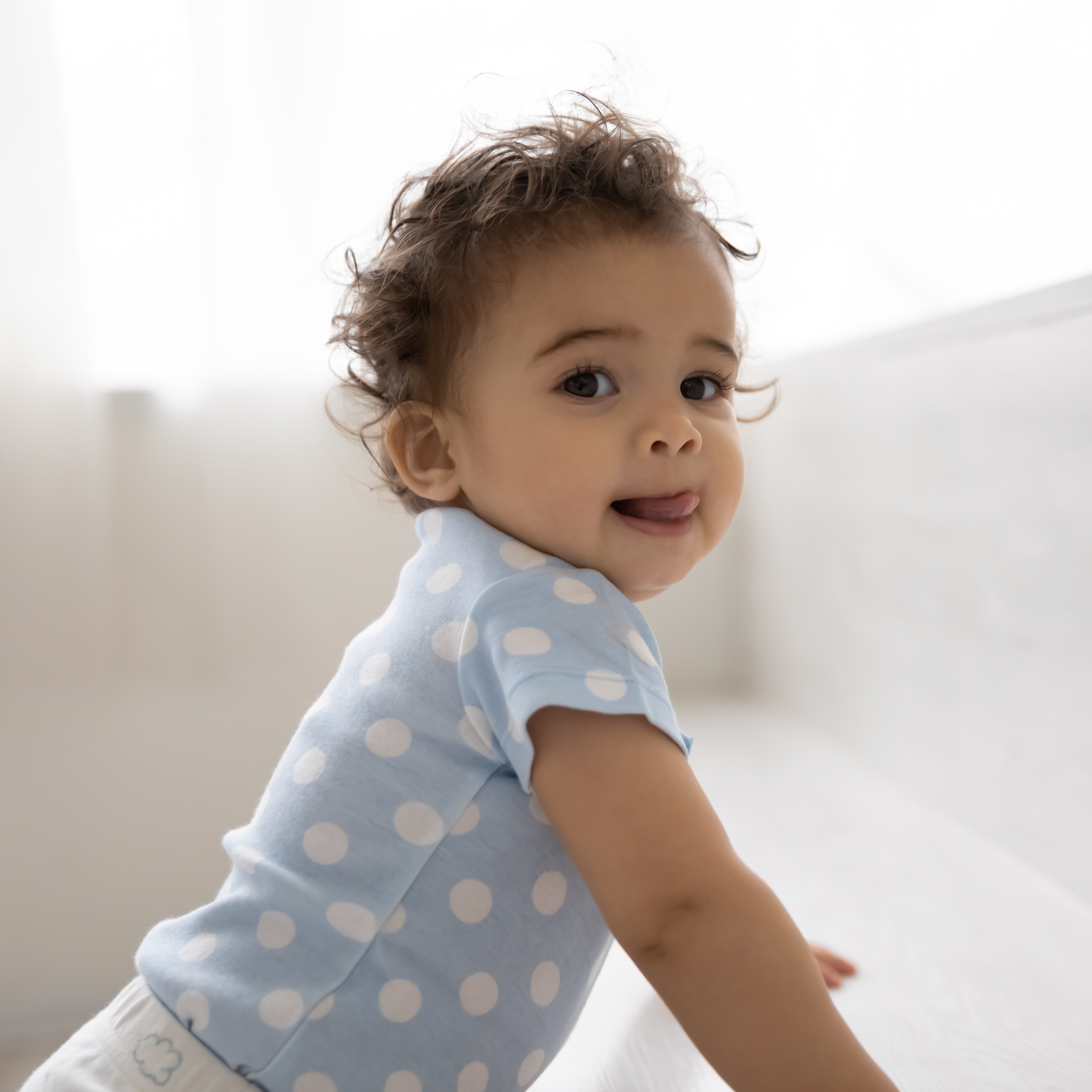 15 month old standing in crib. 