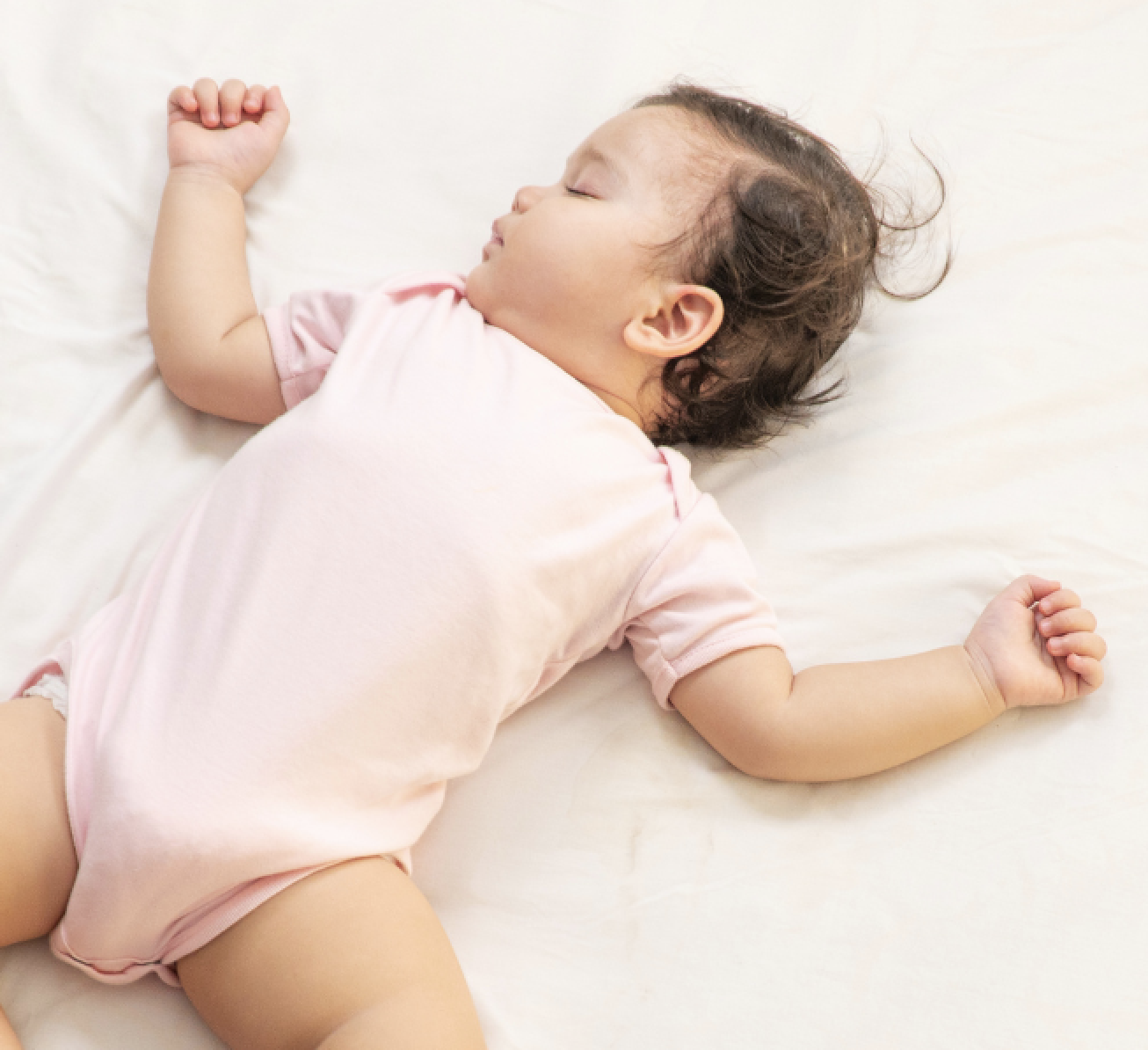 Toddler napping under covers with stuffed animal