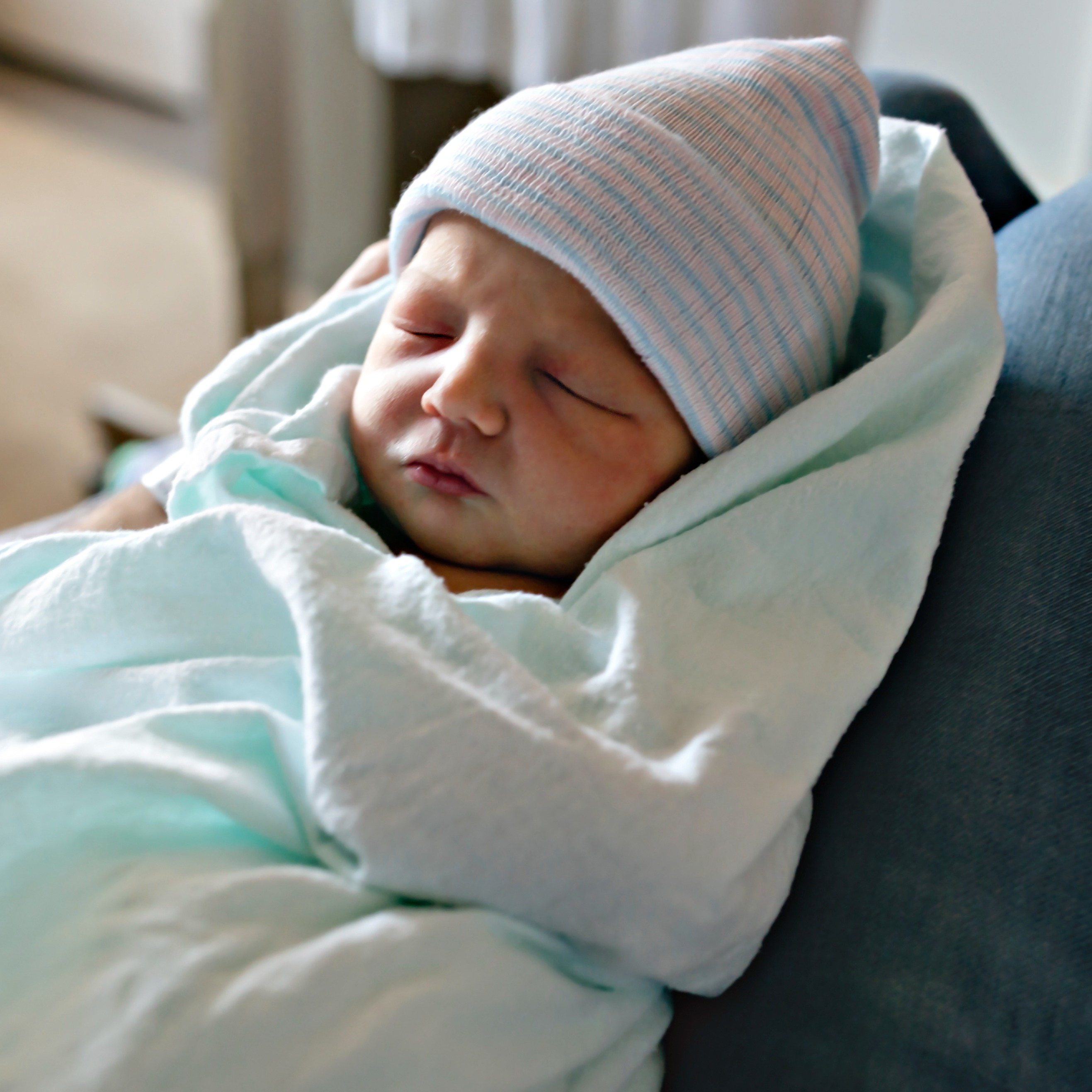 Newborn wearing a hat in the hospital