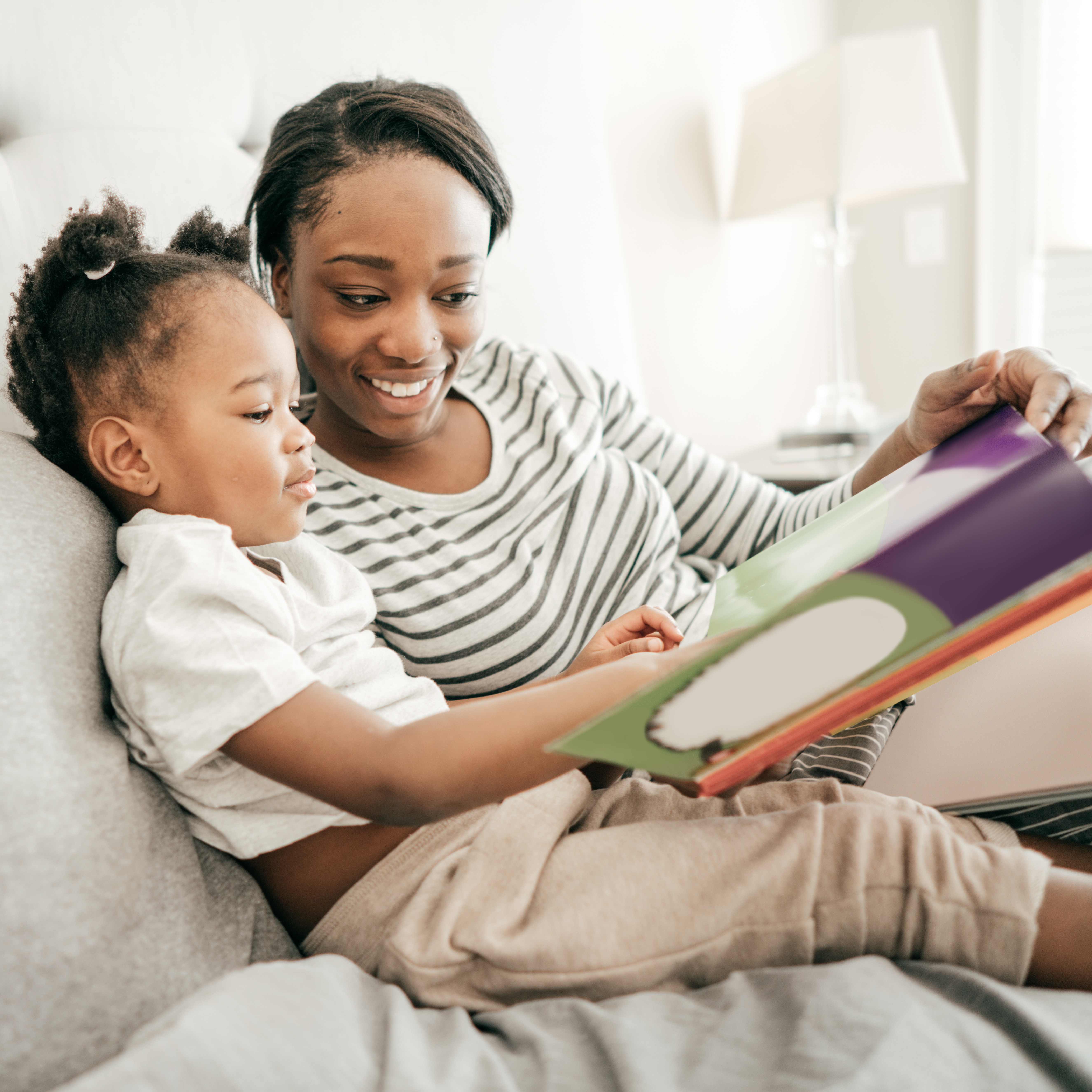 Preschooler reading in bed as part of the bedtime routine.