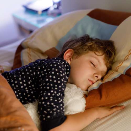 Child sleeping in bed getting good sleep