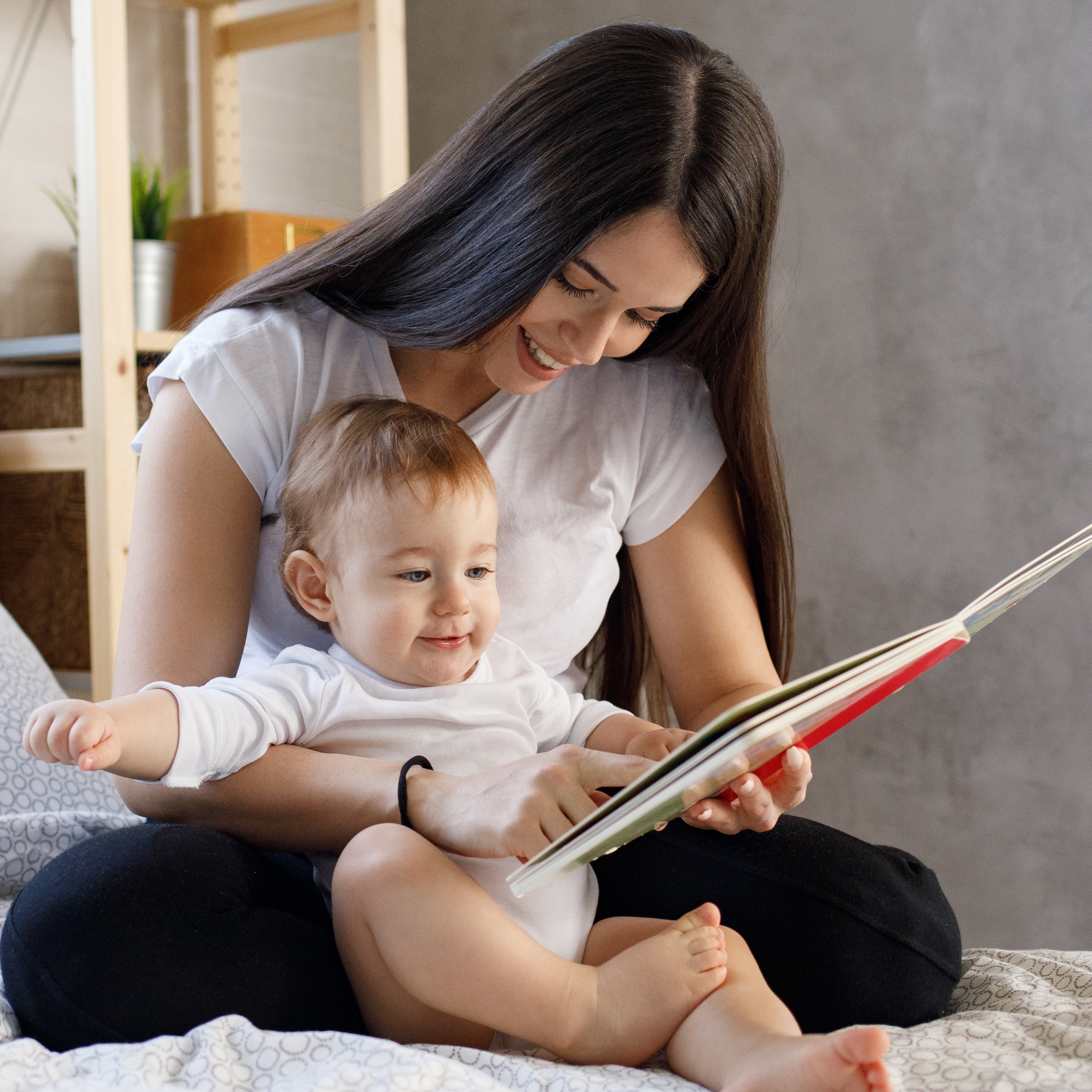 Baby reading bedtime book with parent.