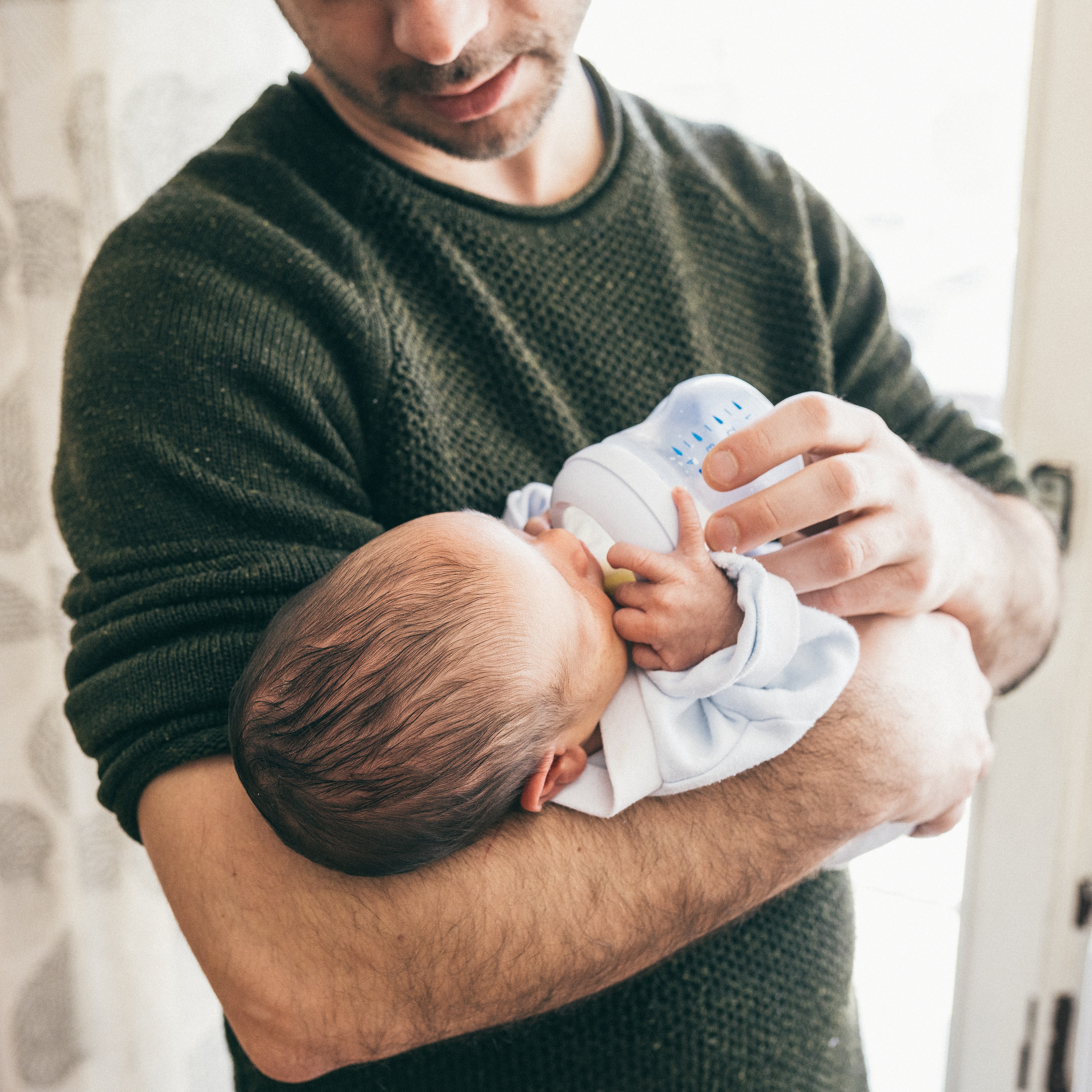 Baby drinking formula from a bottle