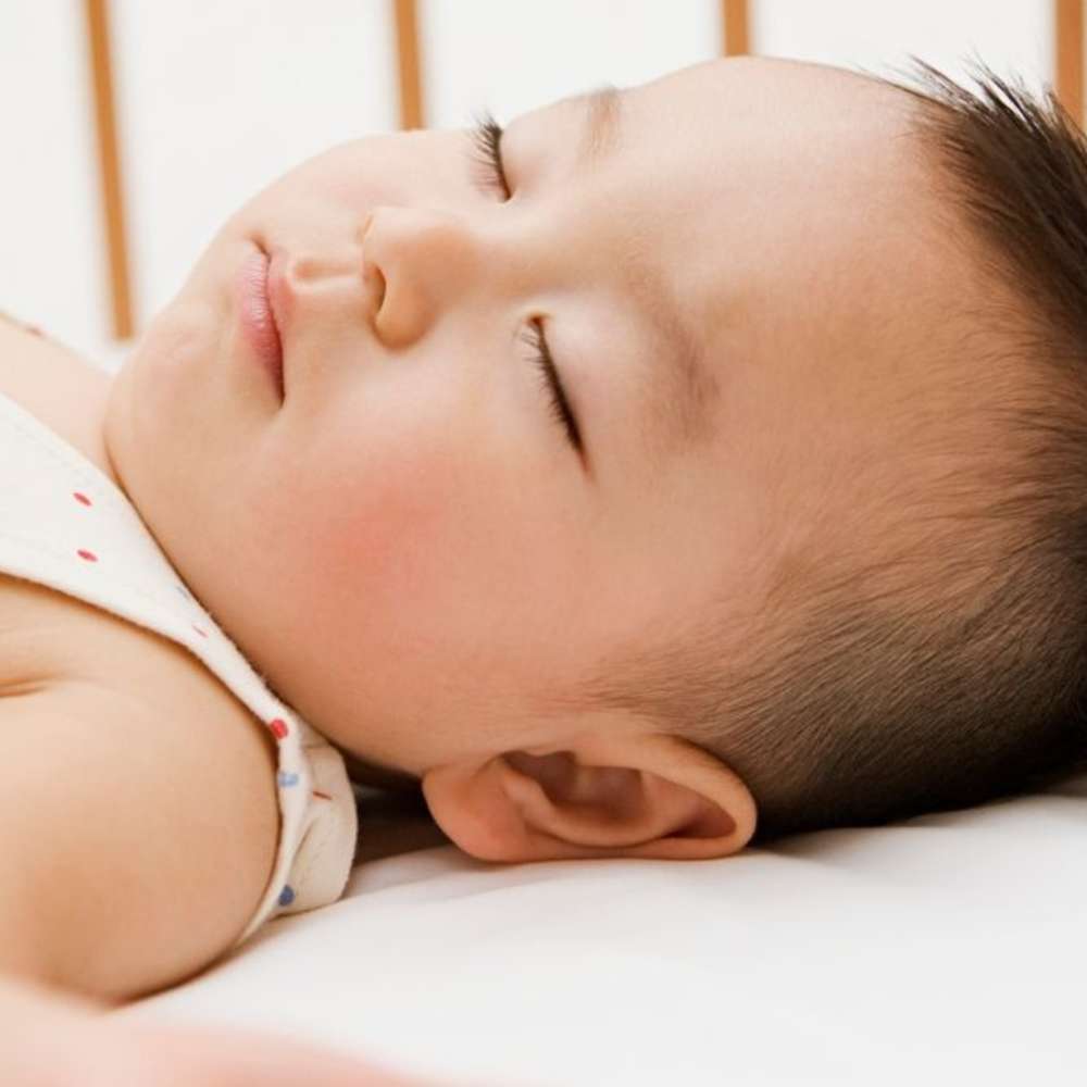 Child sleeping in the crib.