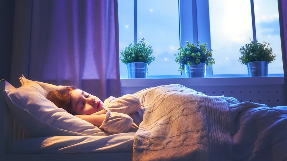 Child sleeping in bed during night time