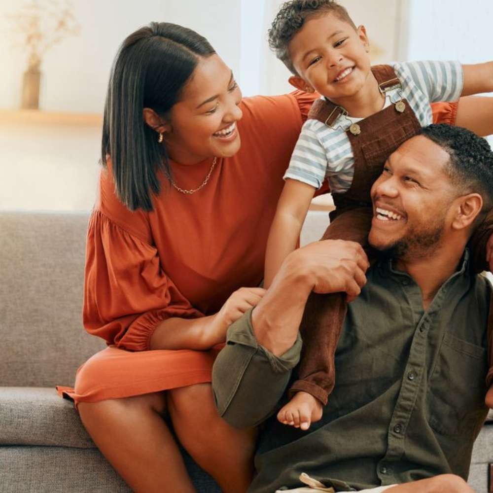 Parents and a child being happy.