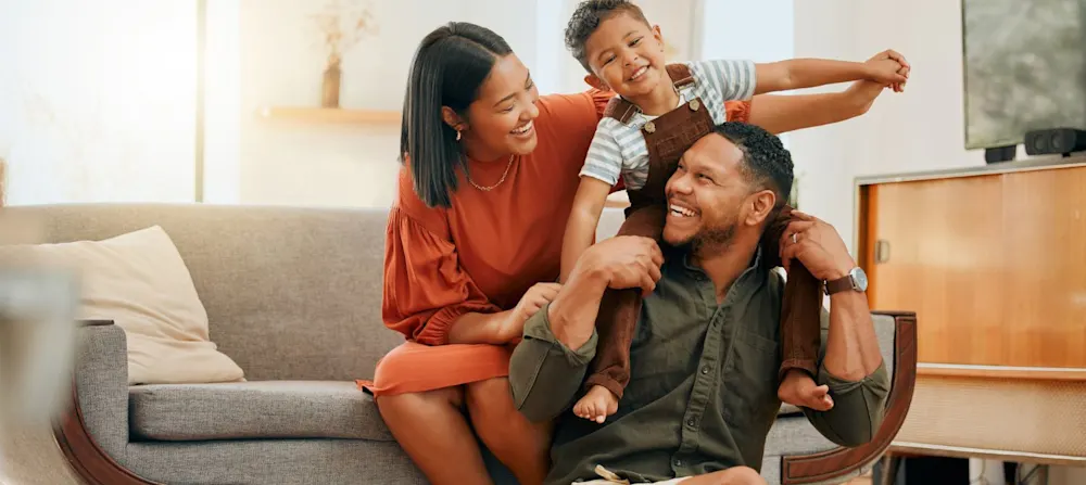 Parents and a child being happy.