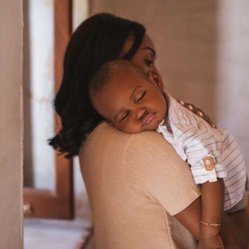 A caregiver holding a baby.